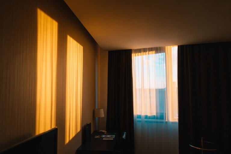 Bright bedroom with morning light through sheer curtains