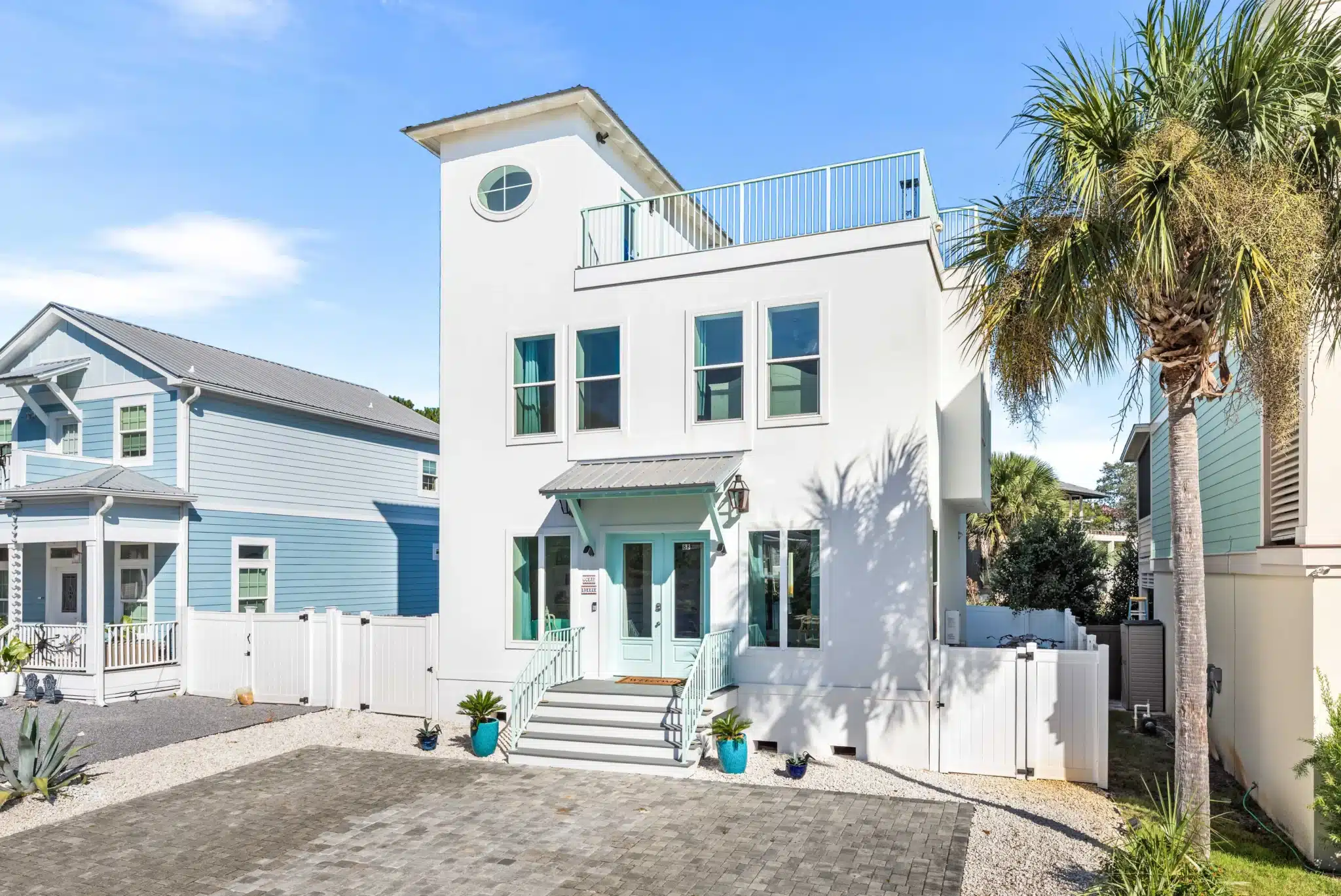 Modern white Ocean Breeze beach house with rooftop deck near hidden gems Blue Mountain Beach