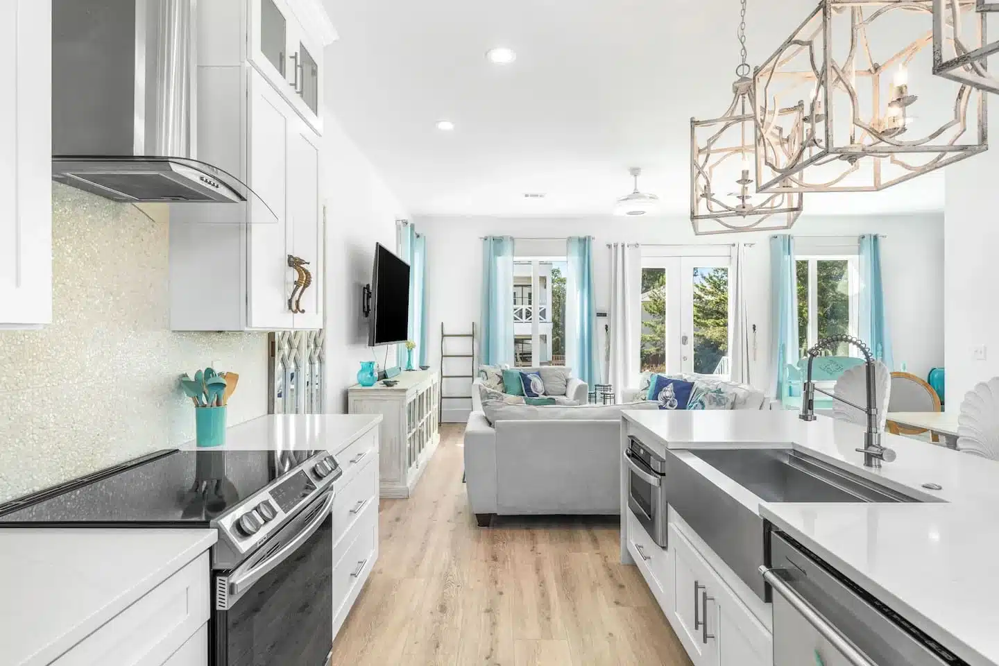 Open-concept kitchen with white cabinets and island at Ocean Breeze Santa Rosa Beach, FL